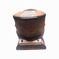 Parte trasera del fuelle de oxígeno para casco de buzo antiguo, con remaches visibles y estructura de madera envejecida.