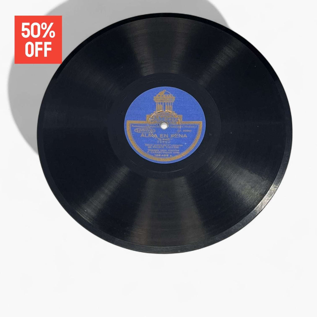 Disco de pizarra antiguo con etiqueta azul de Odeon, parte del lote de 10 discos únicos en oferta del 50%. Ideal para decoración vintage.