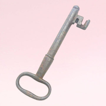Rara llave antigua de forja con diseño robusto y acabado envejecido, ideal como elemento decorativo vintage para el hogar.