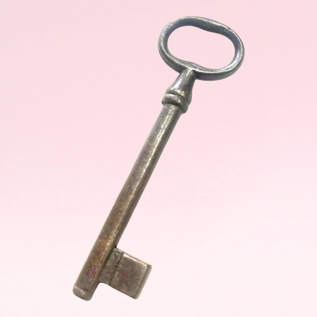 Llave antigua de forja con diseño clásico y acabado metálico, perfecta para decoración de puertas o ambientes con estilo retro o industrial.