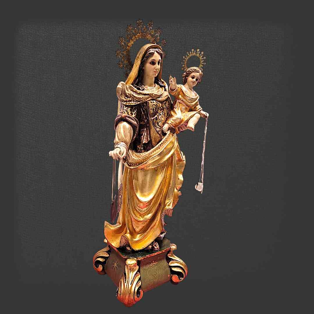 Figura de la Virgen del Carmen de Olot en ángulo, con detalles dorados, ojos de cristal y base decorativa artesanal.