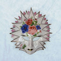 Máscara de porcelana veneciana Galos y Ocer única con diseño floral y bordes puntiagudos, pieza decorativa llamativa para el hogar.