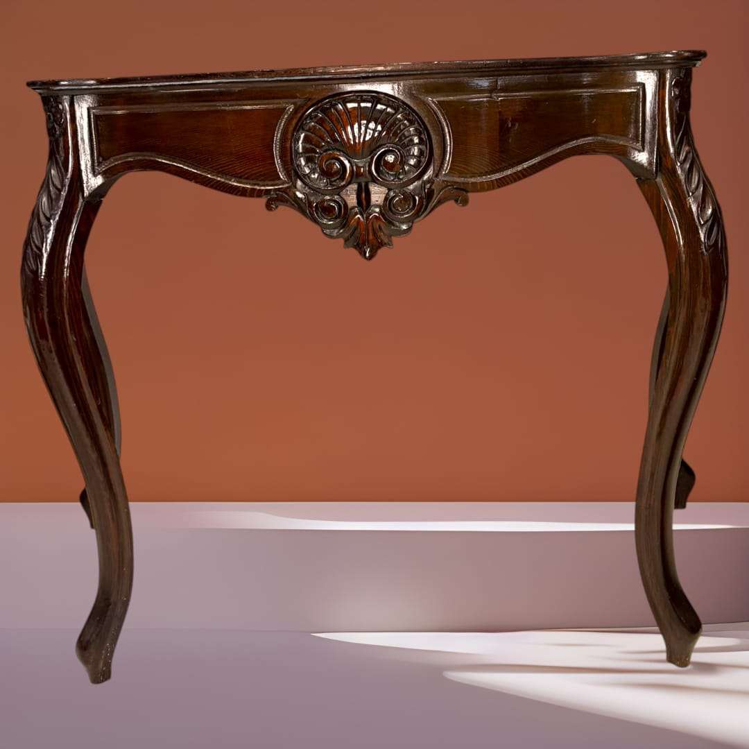 Consola de caoba estilo isabelina con tallado central en forma de concha y patas curvas. Ideal para decoración clásica en entradas o salones.