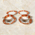 Conjunto completo de porcelana Tú y Yo Alboth & Kaiser Bavaria, con tazas y platos finamente decorados en rojo y dorado, ideal para coleccionistas.