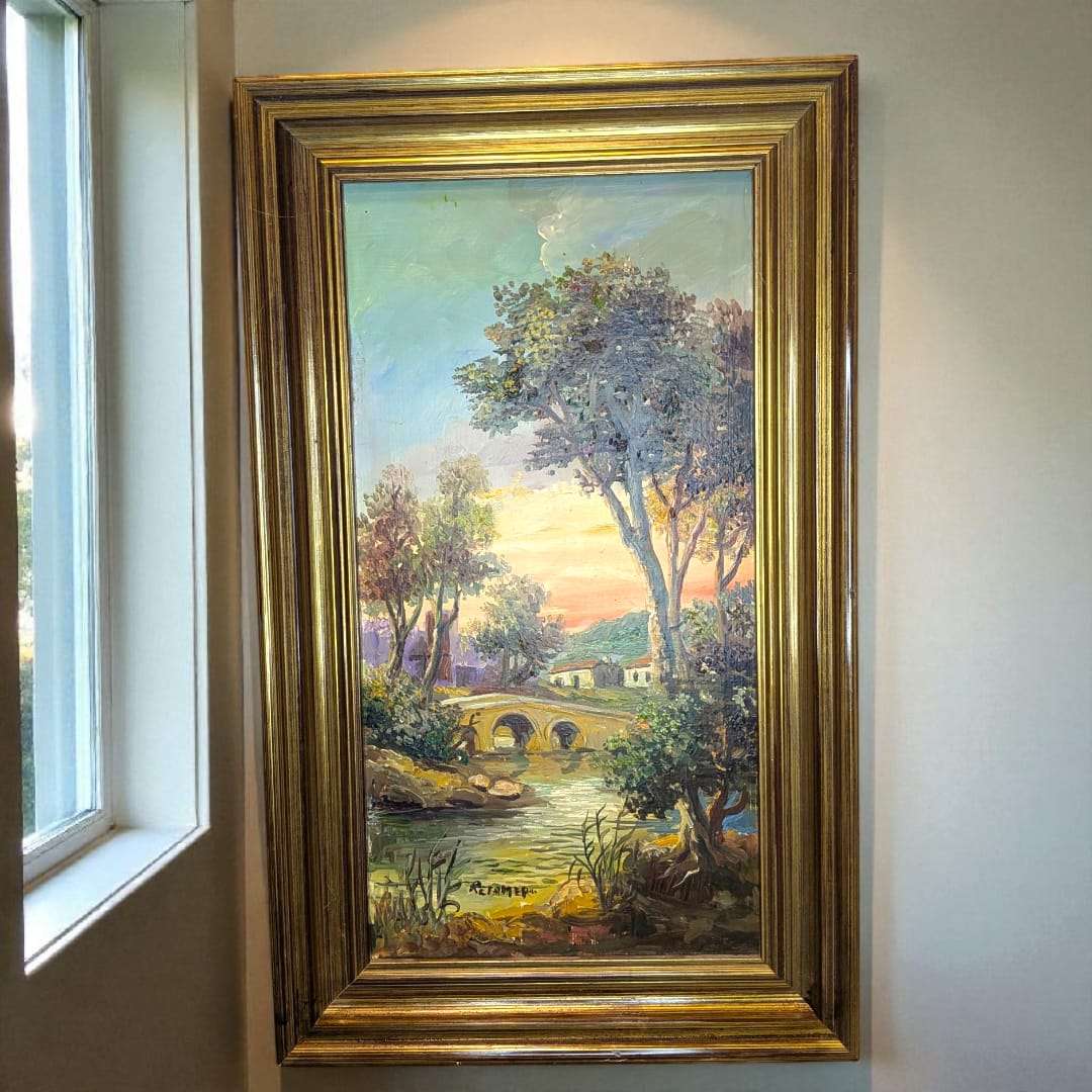 Cuadro de Retamero al óleo, paisaje con puente y río, original enmarcado en dorado, con escena natural al atardecer. Ideal para decoración de interiores.