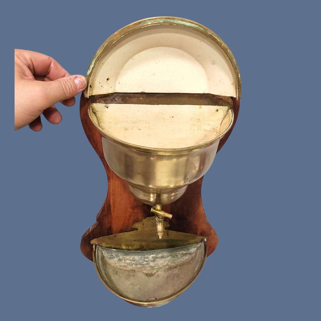 Detalle del soporte de madera tallada con forma sinuosa.