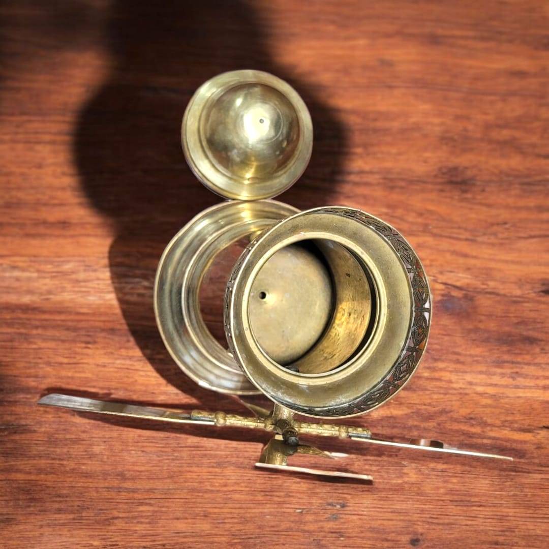Interior del tarro de metal dorado con forma de molino, muestra su capacidad de almacenamiento y diseño funcional.