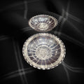 Set de paneras de metal plateado con diseño floral, elegancia funcional para decoración de mesa en comedor o cocina.