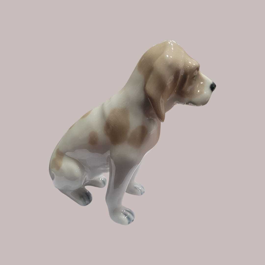 Perro de porcelana Lladró sentado en acabado brillante, figura decorativa ideal para coleccionistas y amantes de la decoración elegante.