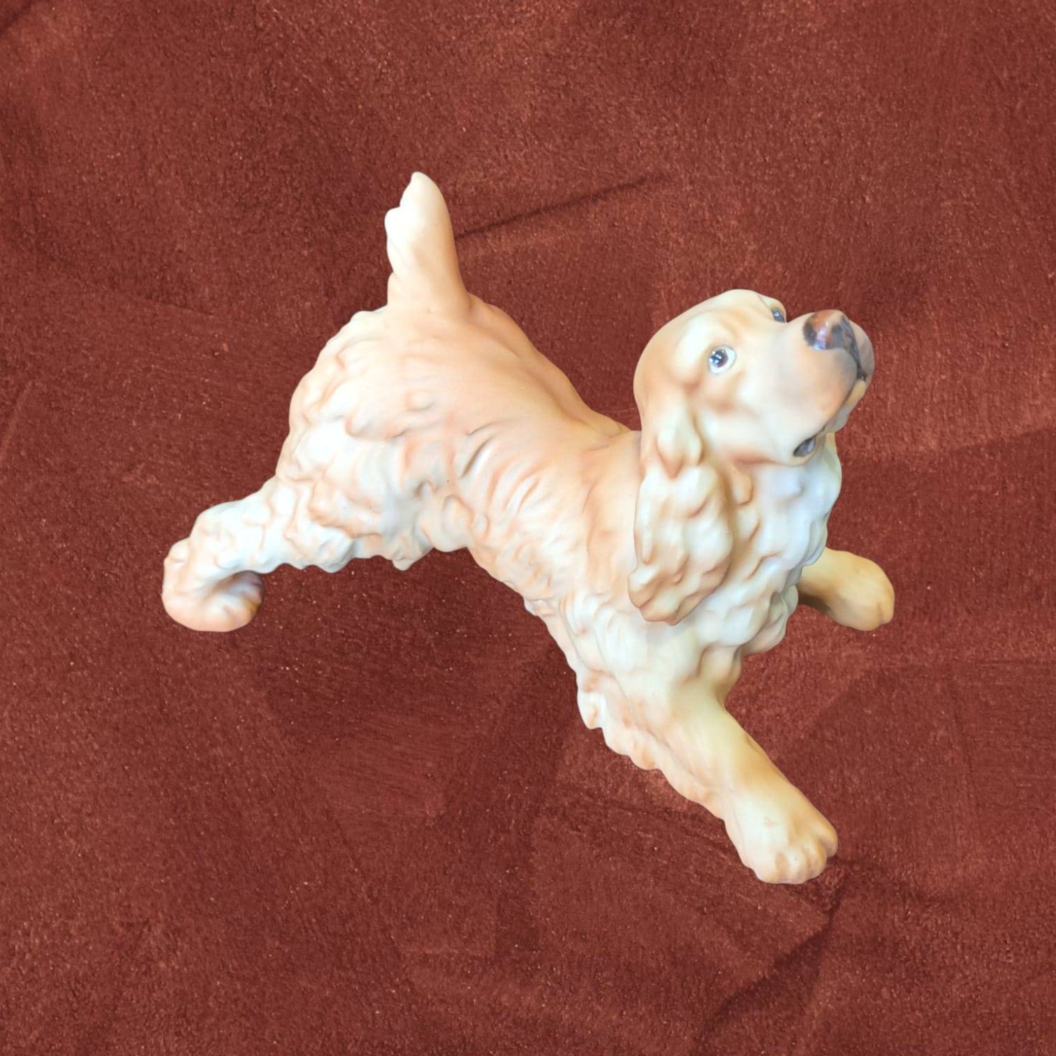 Escultura de perro Cocker Spaniel en biscuit firmada por C. Martinus, pieza decorativa para hogar o colección temática de animales.