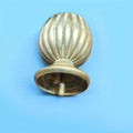 Pomo decorativo de bronce antiguo tumbado en superficie oscura