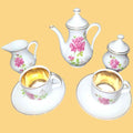 Juego de café 'Tú y Yo' de porcelana con detalles dorados y diseño floral, incluye tazas, platillos, jarra y azucarero.