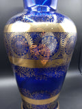 Jarrón de cristal azul cobalto y oro de lujo con detalles ornamentales dorados, ideal para decoración elegante en el hogar. Excelente calidad artesanal.