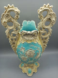 Jarron de ceramica esmaltado con detalles decorativos en tonos azul y marfil, con relieves florales y asas en forma de aves ornamentales. Ideal para decoracion vintage en Home & Garden > Decor.