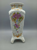 Jarron de porcelana marca Sando con diseño floral en tonos rosados y dorados, ideal para decoración elegante en el hogar. Pieza refinada de alta calidad.