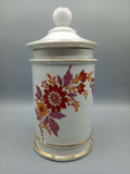 Tarro-Albarelo de Farmacia Antiguo en Porcelana con Decoración Floral en tonos rojos y púrpuras, ideal para decoración vintage en el hogar.