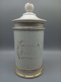 Tarro-Albarelo de Farmacia Antiguo en Porcelana con Decoración Floral, estilo vintage con detalles dorados, ideal para decoración de interiores.