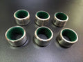 Set de 6 servilleteros de metal plateado con interior verde y números grabados, ideal para decoración de mesa elegante y clásica.