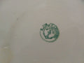 Sello verde de la Cartuja de Sevilla Pickman en la base de una palangana de porcelana antigua, ideal para decoración vintage en el hogar.