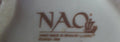 Logotipo de Nao by Lladró grabado en la base de la figura de porcelana, indicando autenticidad y origen español.