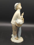 Figura Lladro Pequeño Jardinero de porcelana, vista lateral mostrando cesta de flores y paraguas, pieza decorativa vintage para hogar y jardín.