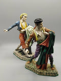 Pareja de figuras Bandoleros Algora en porcelana, representando toreros goyescos con trajes coloridos y base de piedra detallada.