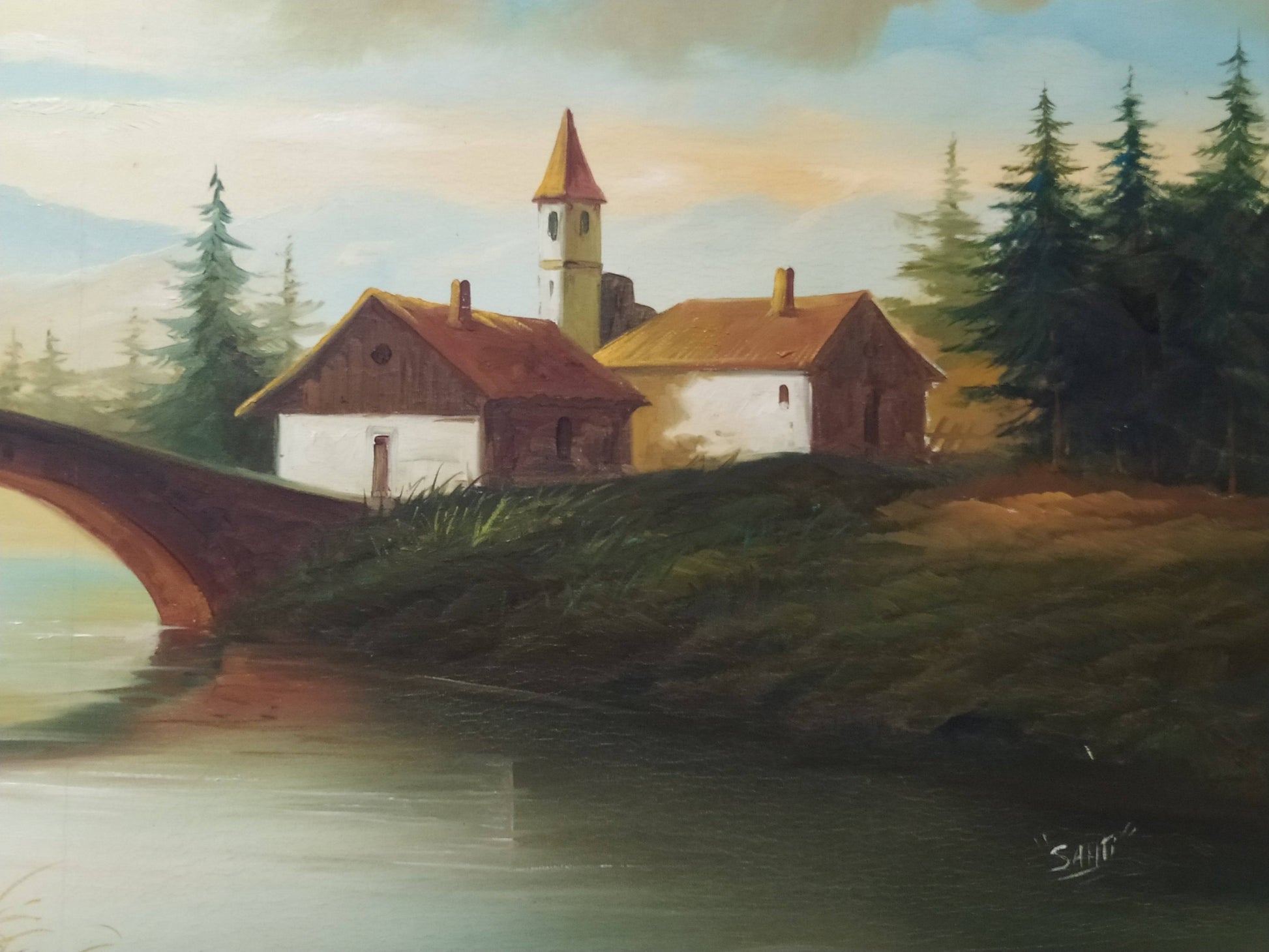 Detalle de óleo de paisaje con casas rurales y puente sobre el río, resaltando texturas y colores vibrantes para un ambiente acogedor.